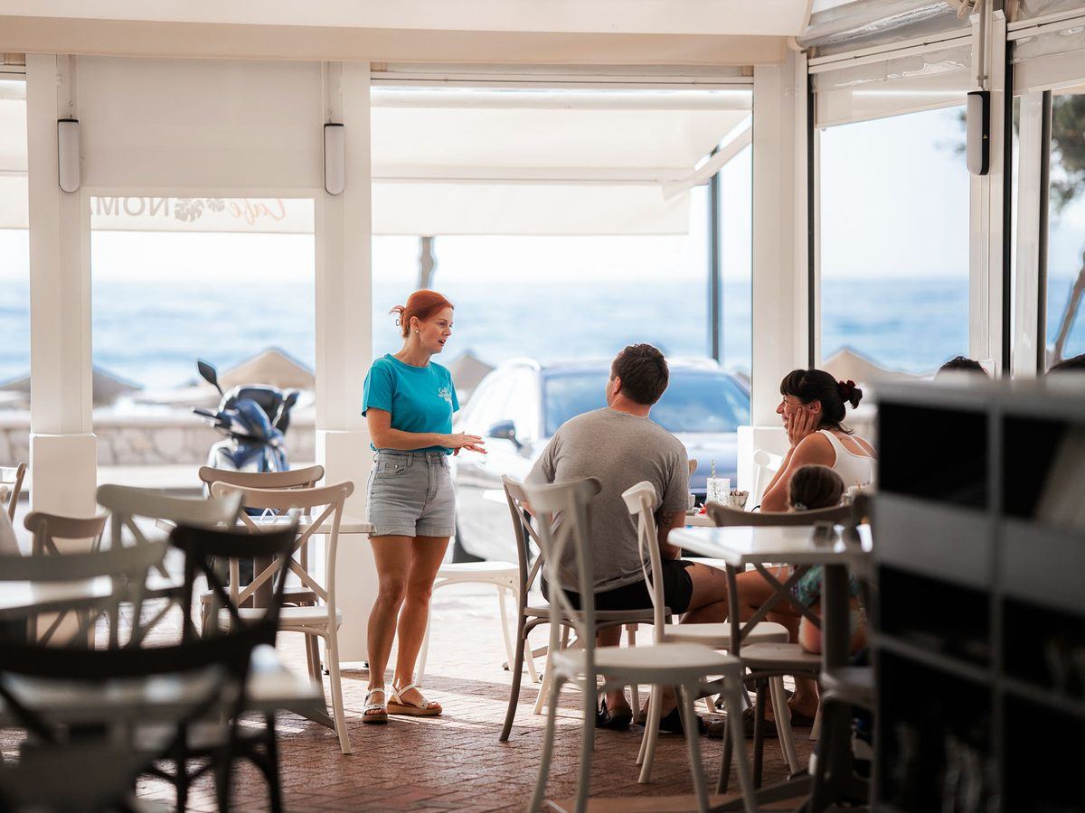 Guests at tables facing the Mediterranean.